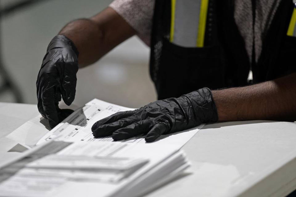 FILE - A worker prepares absentee ballots for mailing at the Wake County Board of Elections in Raleigh, N.C., Sept. 3, 2020. North Carolina Democrats, accused by the Green Party of meddling in its petitioning process to qualify candidates for the November ballot, filed a lawsuit Wednesday, Aug. 3, 2022, asking a state court to overturn a unanimous elections board vote granting the Green Party official recognition despite allegations of fraud. (AP Photo/Gerry Broome, File)