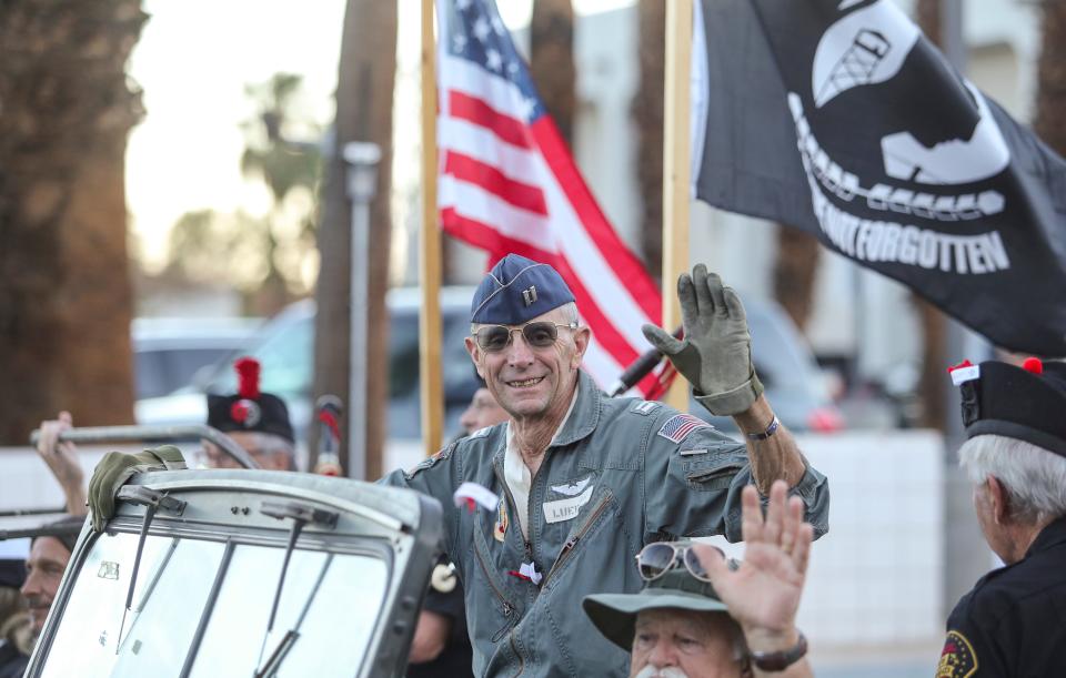 A man waves during the Palm Springs Veterans Day parade, Thursday, Nov. 11, 2021, in Palm Springs, Calif.