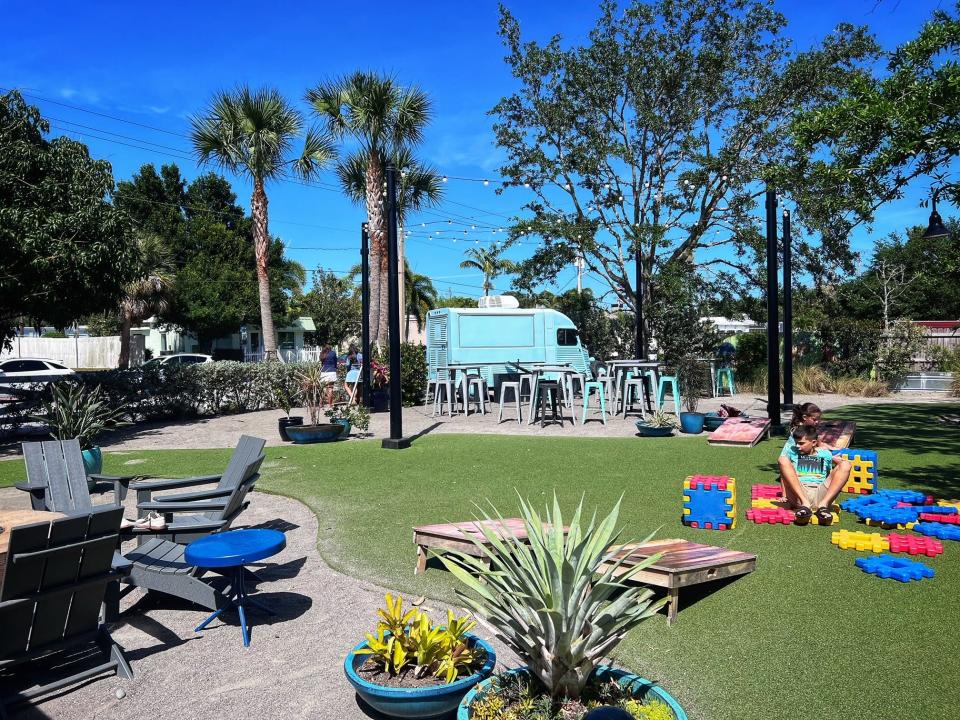 The backyard area at Colab Kitchen restaurant in Stuart offers areas for lounging, play and dining.