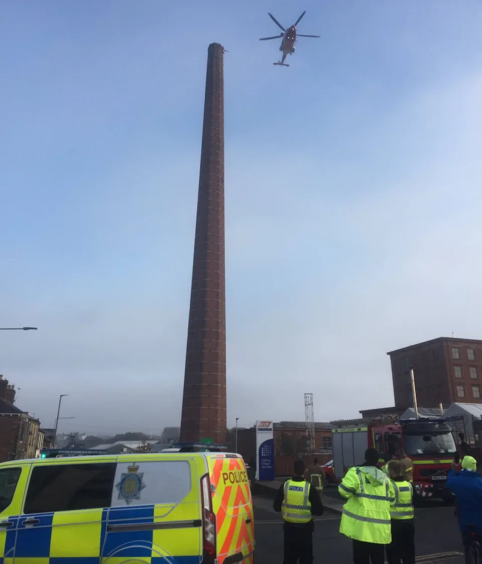 Footage from the scene appears to show a figure, upside down with his legs in the air, at the top of the chimney. (Twitter)