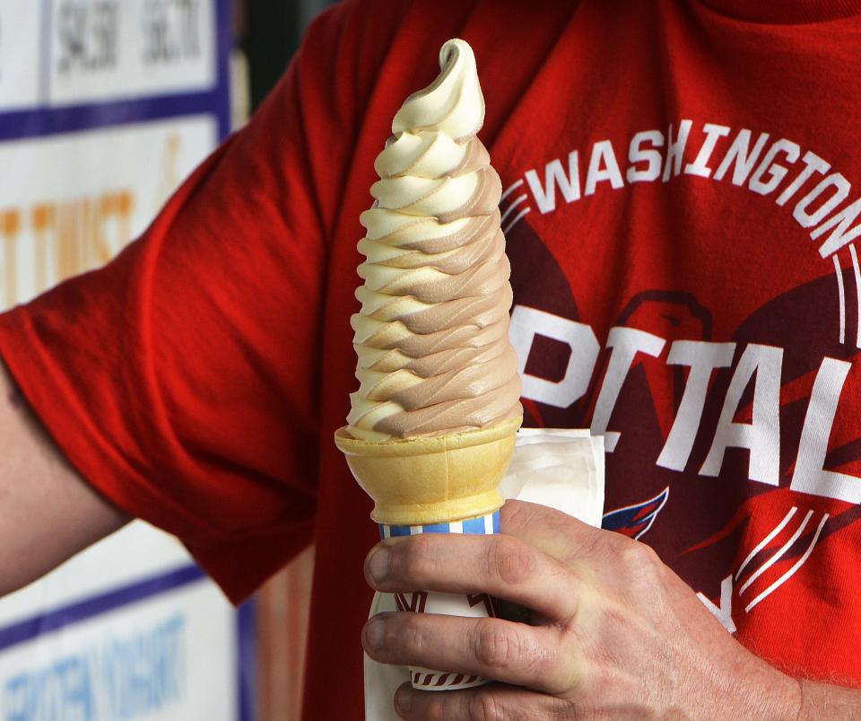 Richy Gambino carries a twisted cone on March 24, 2021, at Denny's Ice Cream Stand in Erie.