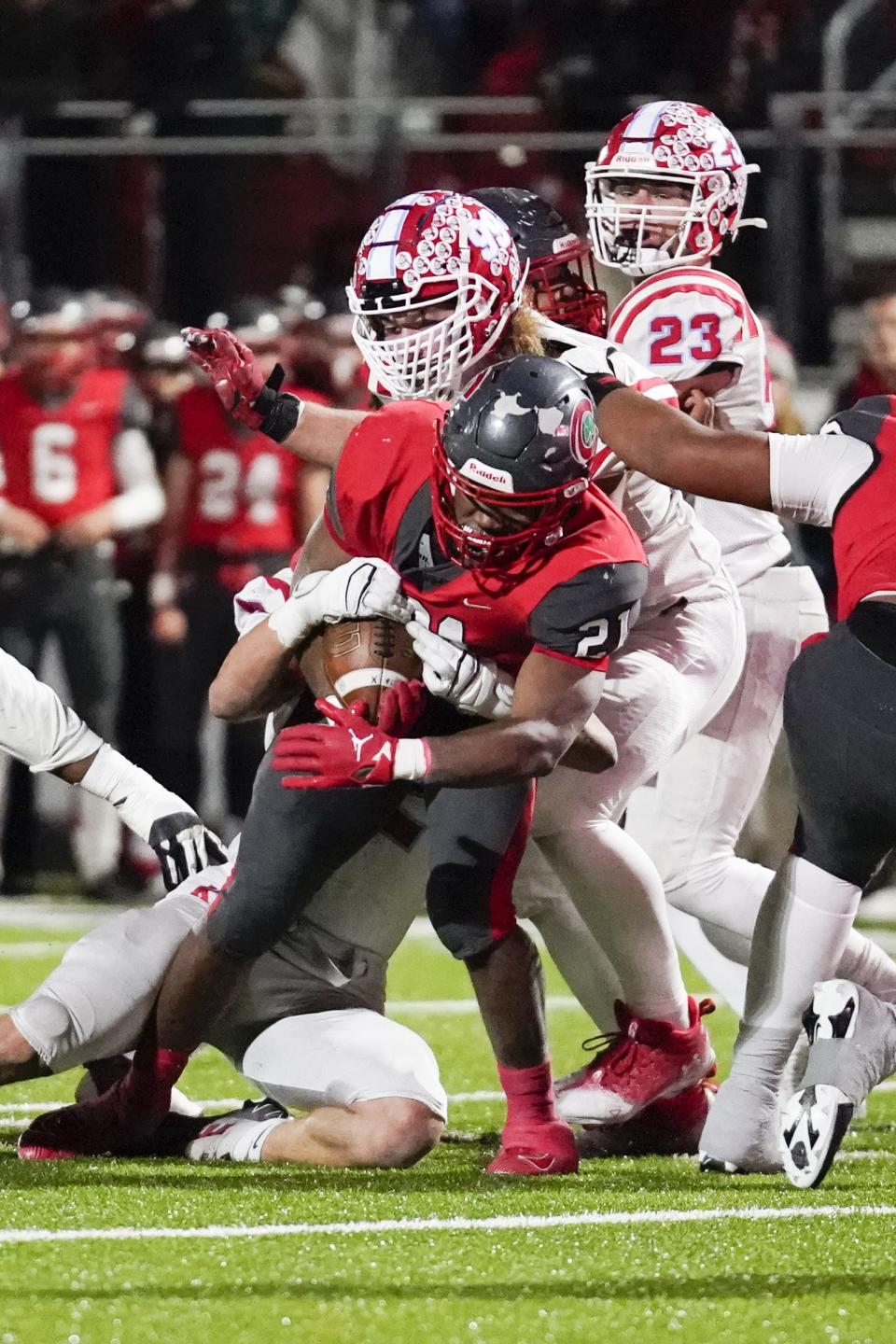 Kings defensive lineman Kai Brown, top, tries to stop Toledo Central Catholic running back Chris Edmonds (21) during the third quarter of a Division II state semifinal last week.