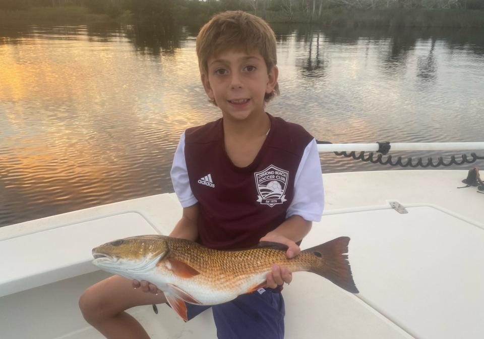 Connor Grasso, of Ormond Beach, shows off a chunky redfish he caught while fishing with Capt. Jeff Patterson.