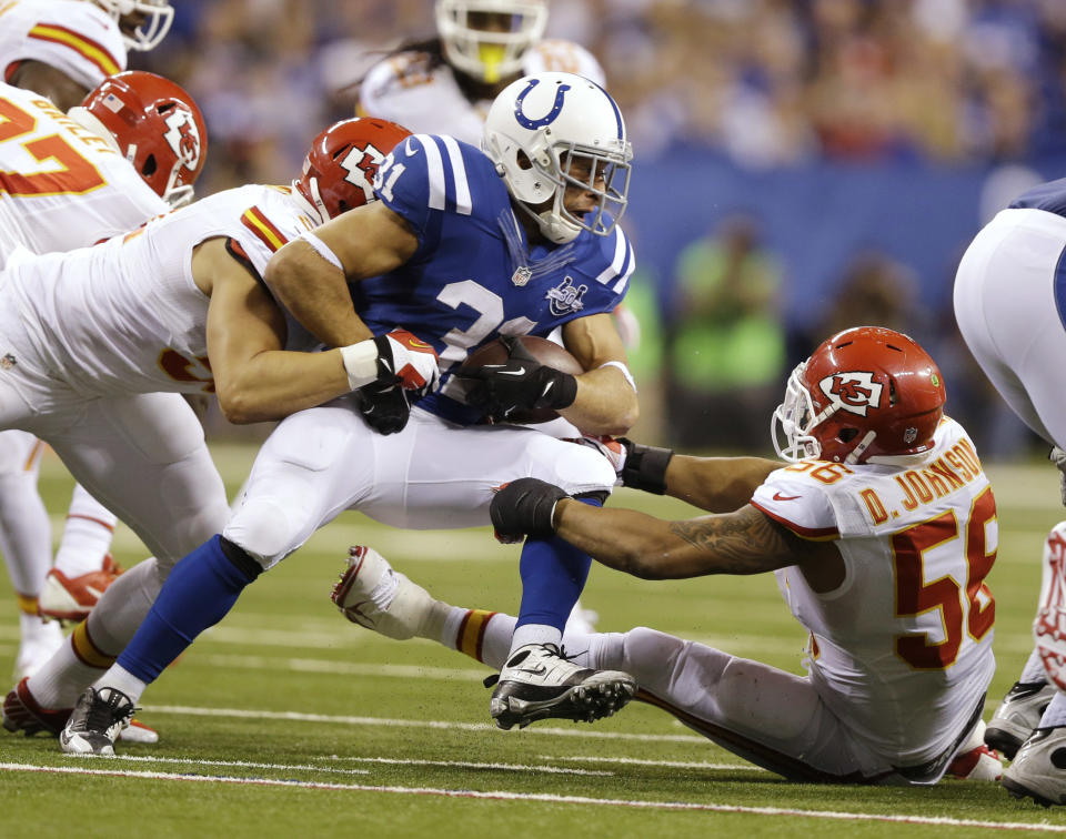 Indianapolis Colts' Donald Brown (31) is tackled buy Kansas City Chiefs' Derrick Johnson (56) during the second half of an NFL wild-card playoff football game Saturday, Jan. 4, 2014, in Indianapolis. (AP Photo/Michael Conroy)