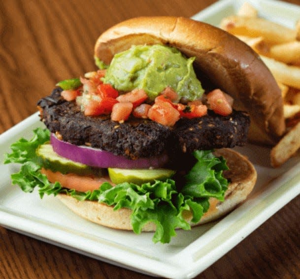 The 99 has a chipotle-spiced black bean burger, topped with pico de gallo and guacamole