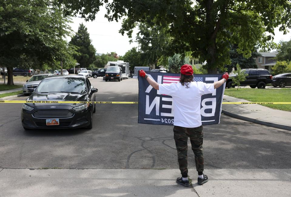 A Donald Trump supporter displays an anti-Joe Biden flag toward law enforcement agents as they investigate at the residence of Craig Deeleuw Robertson them in Provo on Wednesday, Aug. 9, 2023. | Laura Seitz, Deseret News