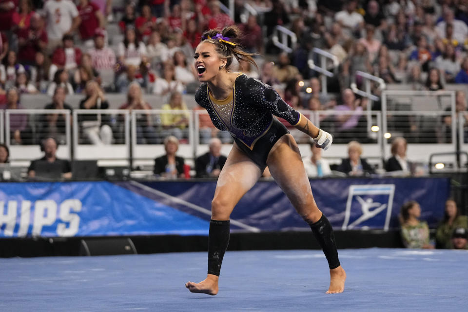 LSU's KJ Johnson celebrates after competing in the floor exercise during the NCAA women's gymnastics championships in Fort Worth, Texas, Thursday, April 18, 2024. (AP Photo/Tony Gutierrez)