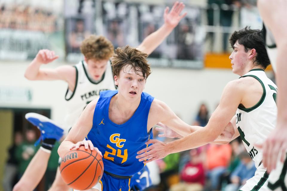 Greenfield-Central Cougars Braylon Mullins (24) dribbles the ball down the court amid defenders on Friday, Jan. 26, 2024, during the game at Pendleton Heights High School in Pendleton. The Greenfield-Central Cougars defeated the Pendleton Heights Arabians 74-72 in double overtime.