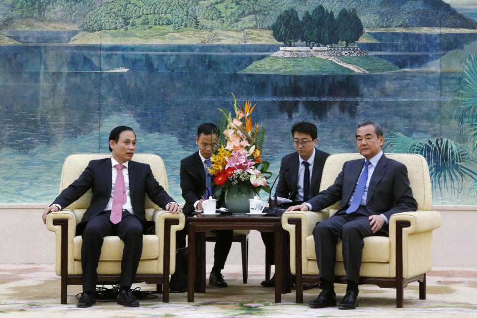 FILE - In this Nov. 27, 2019, file photo, Vietnam's Deputy Foreign Minister Le Hoai Trung, left, attends a meeting with Chinese Foreign Minister Wang Yi at the Great Hall of the People in Beijing. Leading diplomats from Vietnam and China sought to patch up relations after a new round of tensions over China’s oil exploration activities in waters claimed by Hanoi. (Florence Lo/Pool Photo via AP, File)