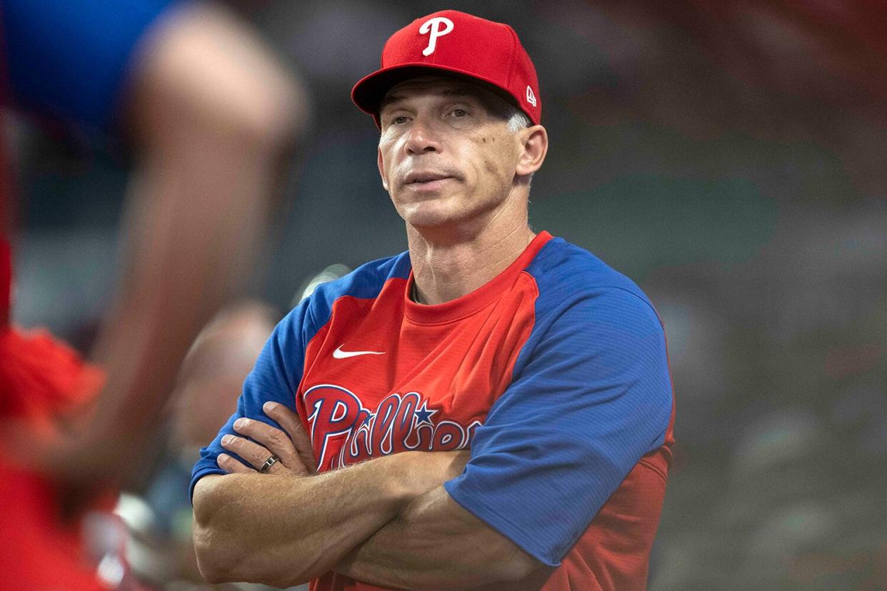 Joe Girardi #25 of the Philadelphia Phillies in the dugout during the fourth inning against the Atlanta Braves at Truist Park on May 24, 2022 in Atlanta, Georgia.