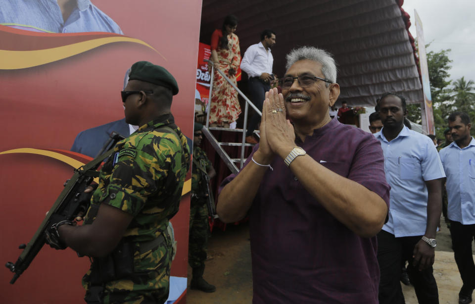 Sri Lankan presidential candidate and former defense chief Gotabaya Rajapaksa greets the gathering as he leaves after addressing an election rally in Neluwa village in Galle, Sri Lanka, Tuesday, Oct. 22, 2019. The daughter of a Sri Lankan journalist assassinated during the country's civil war says she'll appeal a U.S. court's decision to throw out her lawsuit against Rajapaksa, the front-runner in Sri Lanka's upcoming presidential election. Rajapaksa was defense chief when Lasantha Wickrematunge, editor of the Sunday Leader newspaper, was killed in January 2009, around four months before the end of the long civil war. (AP Photo/Eranga Jayawardena)