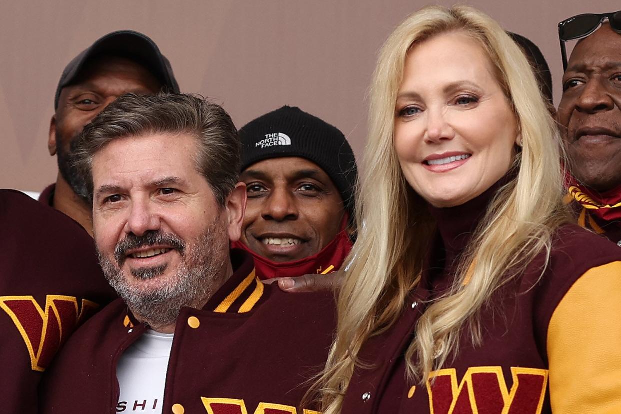 LANDOVER, MARYLAND - FEBRUARY 02: Team co-owners Dan and Tanya Snyder pose for a photo with former team members during the announcement of the Washington Football Team's name change to the Washington Commanders at FedExField on February 02, 2022 in Landover, Maryland. (Photo by Rob Carr/Getty Images)