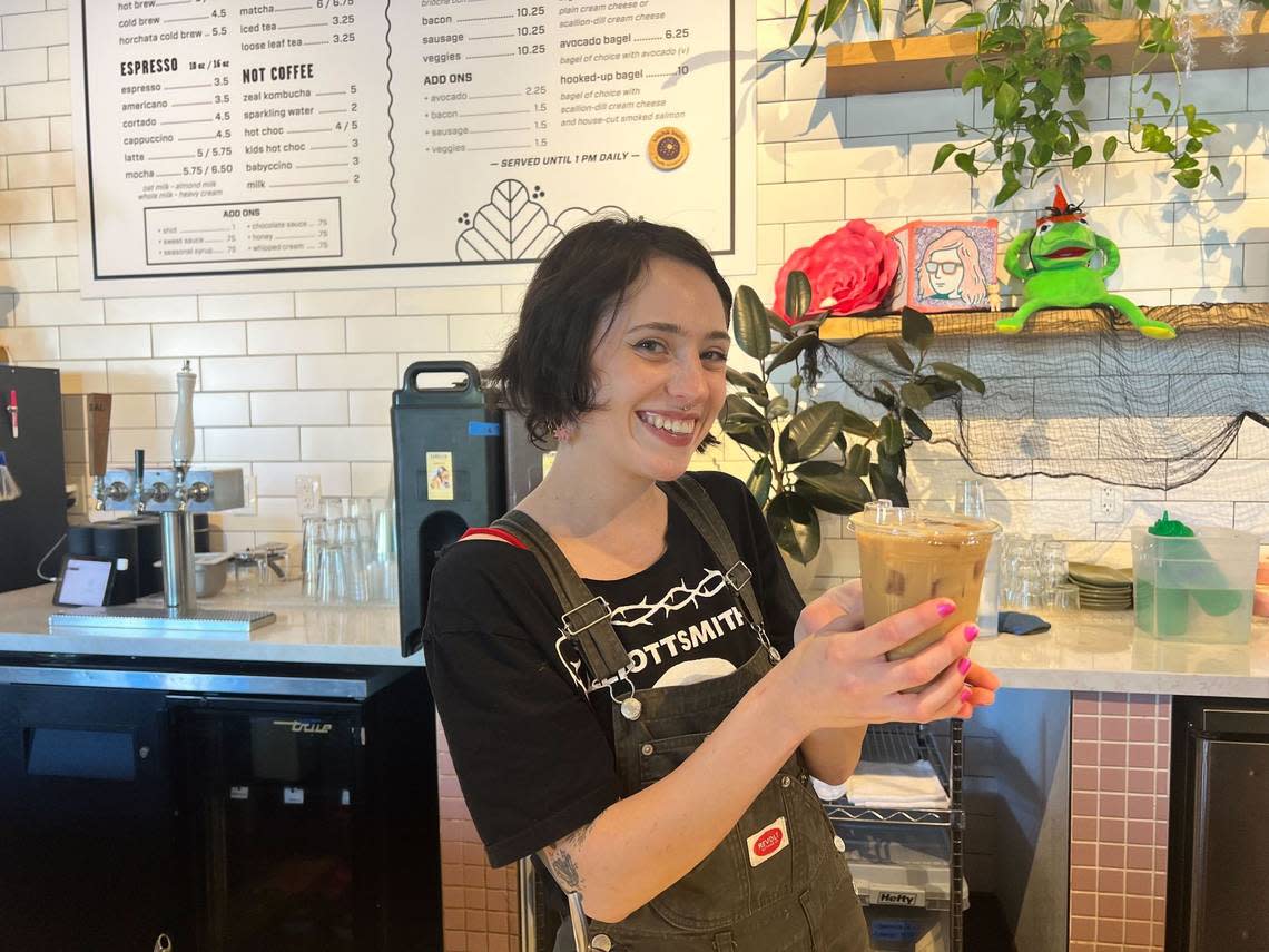 Barista Shelby Weisker, 25, poses with an iced oatmilk latte flavored with Camellia Coffee Roaster’s new fall Cozy Spice Syrup. The syrup can be added to any espresso drink on the menu. Camellia is located at 1200 R St Suite 130.