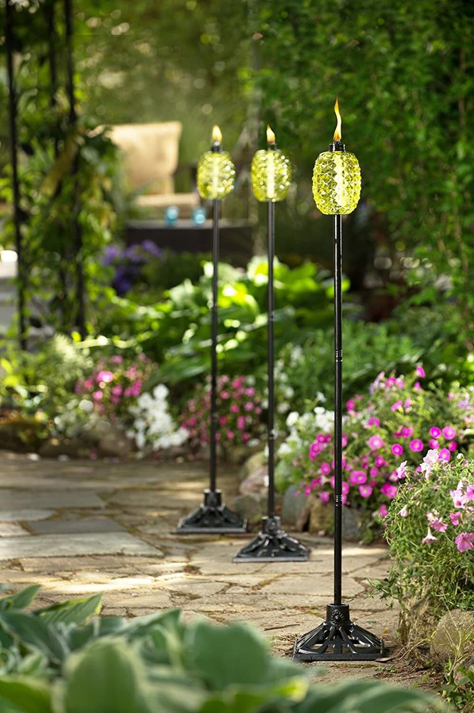 This torch will add a little SpongeBob flair to your garden and provide just the right amount of light for nighttime activities. Plus, you can take off the metal pole part and use it as a table centerpiece! <br /><br /><strong>Promising review:</strong> "This pineapple torch couldn't be cuter. I bought a few for my home in Florida and the decor is just perfect. <strong>I love how cute they look in my yard even when I am not using them.</strong> The tiki fuel that goes with the torches is also great for keeping bugs away." &mdash; <a href="https://amzn.to/3azIgXn" target="_blank" rel="nofollow noopener noreferrer" data-skimlinks-tracking="5580838" data-vars-affiliate="Amazon" data-vars-href="https://www.amazon.com/gp/customer-reviews/R2MQ6PJJCQ1CPX?tag=bfgenevieve-20&amp;ascsubtag=5580838%2C7%2C33%2Cmobile_web%2C0%2C0%2C1159931" data-vars-keywords="cleaning,fast fashion" data-vars-link-id="1159931" data-vars-price="" data-vars-product-id="16176775" data-vars-retailers="Amazon">Amazon Customer</a><br /><br /><strong>Get it from Amazon for <a href="https://amzn.to/2Qhfh3R" target="_blank" rel="nofollow noopener noreferrer" data-skimlinks-tracking="5580838" data-vars-affiliate="Amazon" data-vars-asin="B078PVLC59" data-vars-href="https://www.amazon.com/dp/B078PVLC59?tag=bfgenevieve-20&amp;ascsubtag=5580838%2C7%2C33%2Cmobile_web%2C0%2C0%2C1159987" data-vars-keywords="cleaning,fast fashion" data-vars-link-id="1159987" data-vars-price="" data-vars-product-id="16176774" data-vars-product-img="https://m.media-amazon.com/images/I/41JNwKtplkL.jpg" data-vars-product-title="TIKI 1117095 Outdoor Torch, 65&quot;, Green" data-vars-retailers="Amazon">$32.92</a>.</strong>