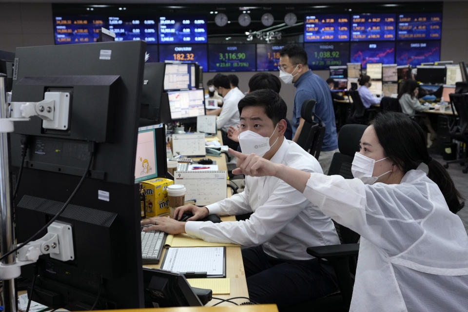 Currency traders work at the foreign exchange dealing room of the KEB Hana Bank headquarters in Seoul, South Korea, Thursday, Sept. 23, 2021. Asian shares were mostly higher on Thursday after the Federal Reserve signaled it may begin easing its extraordinary support measures for the economy later this year. (AP Photo/Ahn Young-joon)