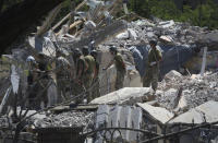 Ukrainian State Emergency Service firefighters work at damaged residential building in the town of Serhiivka, located about 50 kilometers (31 miles) southwest of Odesa, Ukraine, Friday, July 1, 2022. Russian missile attacks on residential areas in a coastal town near the Ukrainian port city of Odesa early Friday killed at least 19 people, authorities reported, a day after Russian forces withdrew from a strategic Black Sea island. (AP Photo/Nina Lyashonok)