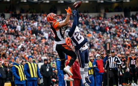 New England Patriots cornerback Stephon Gilmore (24) breaks up a pass to Cincinnati Bengals wide receiver Tyler Boyd (83) in the second half of an NFL football game, Sunday, Dec. 15, 2019, in Cincinnati - Credit: AP