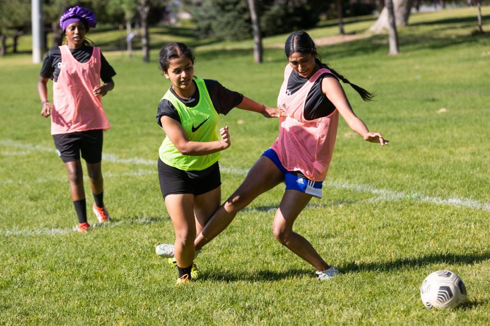 Romisha Adhikari, of Nepal, center, and Anu Arumugarasa, of Sri Lanka, right scrimmage at their #SheBelongs soccer practice at Lone Peak Park in Sandy on Thursday, July 6, 2023. #SheBelongs is a four-month program bringing together refugee and nonrefugee girls through soccer. | Megan Nielsen, Deseret News