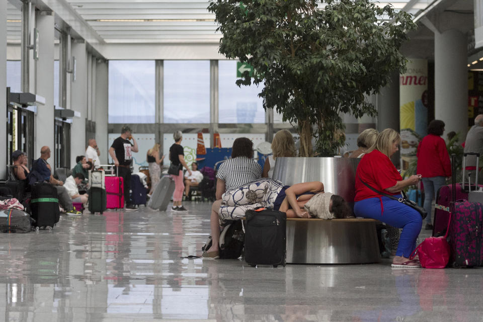 British passengers wait for news on cancelled Thomas Cook flights at Palma de Mallorca airport on Monday Sept. 23, 2019. Spain's airport operator AENA says that 46 flights have been affected by the collapse of the British tour company Thomas Cook, mostly in the Spanish Balearic and Canary archipelagos. (AP Photo/Francisco Ubilla)