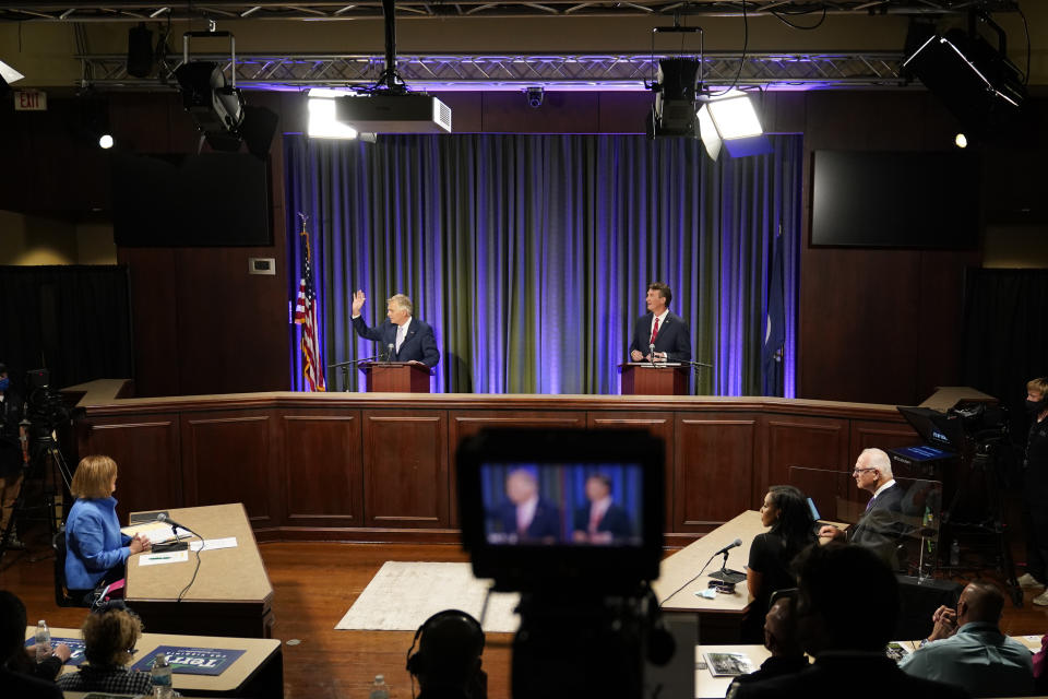 Democratic gubernatorial candidate former Governor Terry McAuliffe, left, and Republican challenger, Glenn Youngkin, prepare for a debate at the Appalachian School of Law in Grundy, Va., Thursday, Sept. 16, 2021. (AP Photo/Steve Helber)