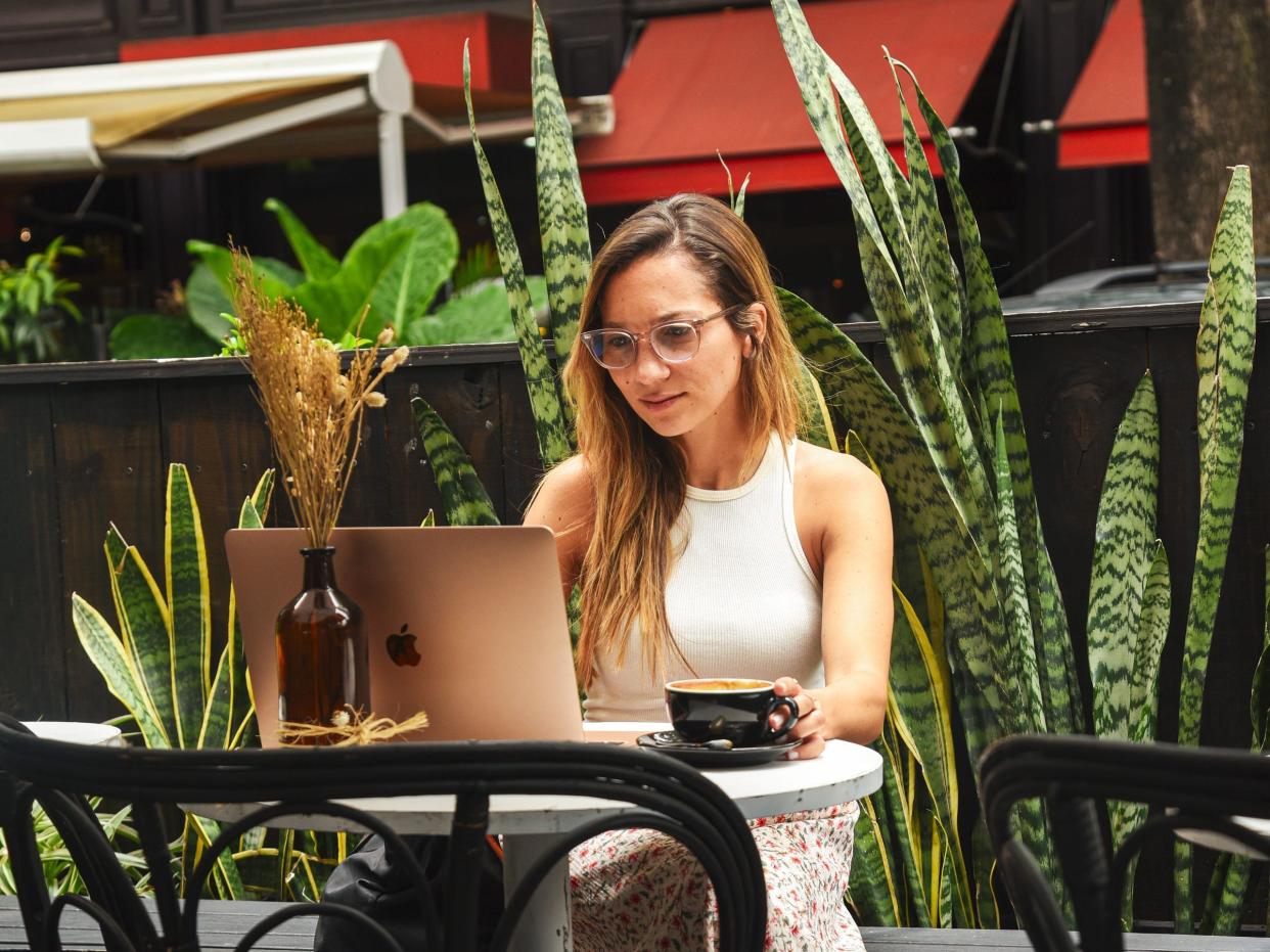 Digital nomad career coach Kristin Vierra working at a cafe in Buenos Aires.