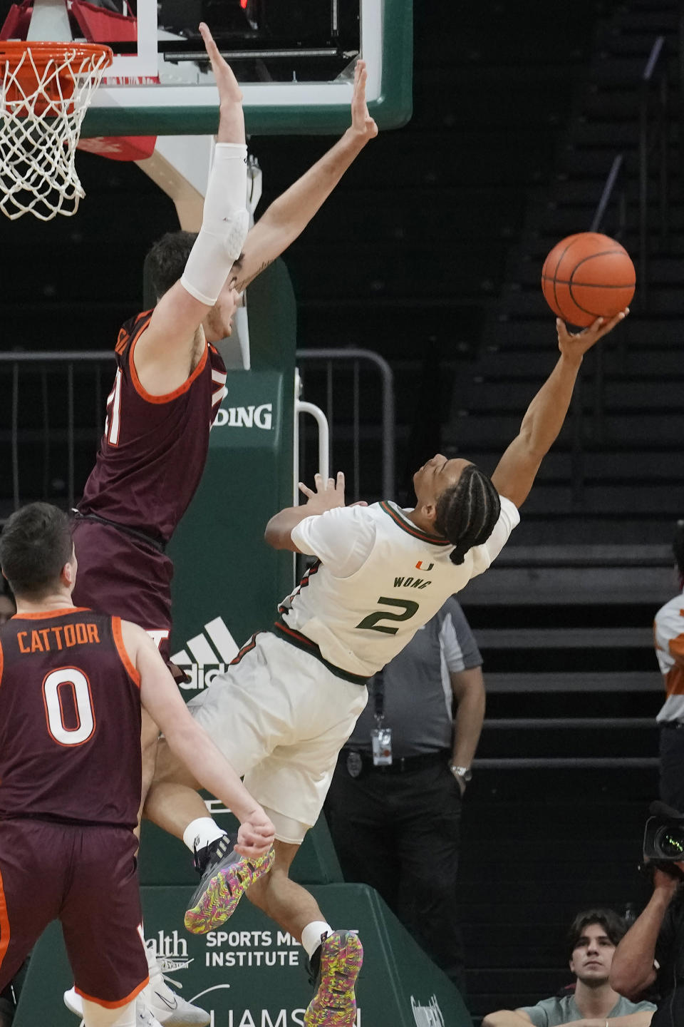 Miami guard Isaiah Wong (2) is fouled by Virginia Tech forward Grant Basile (21) during the first half of an NCAA college basketball game, Tuesday, Jan. 31, 2023, in Coral Gables, Fla. (AP Photo/Marta Lavandier)