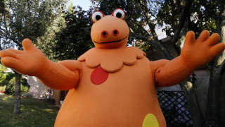 French co-creator and interpreter of Casimir, Yves Brunier poses in his Casimir costume in Saint-Maur-des-Fosses, near Paris, on September 16, 2014. Brunier, who played the orange dinosaur that presented during eight years the TV show for children 
