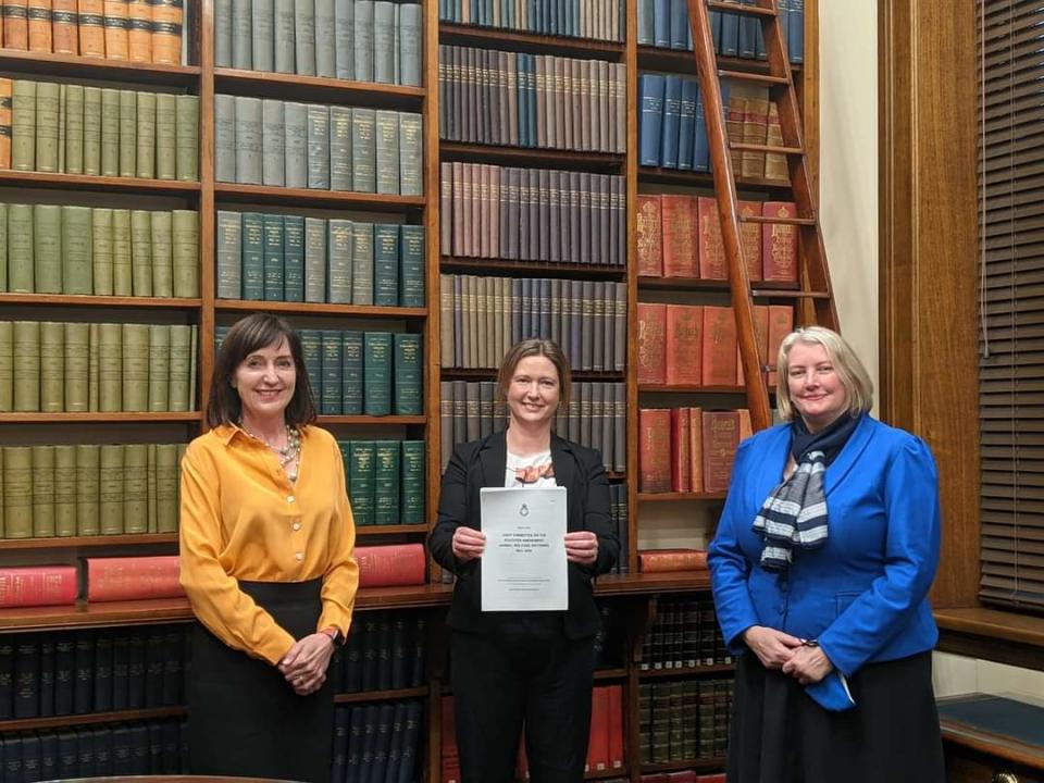 Ms Aukland holds the bill while standing with Tammy Franks and Dr Susan Close, the deputy premier and minister of environment, 