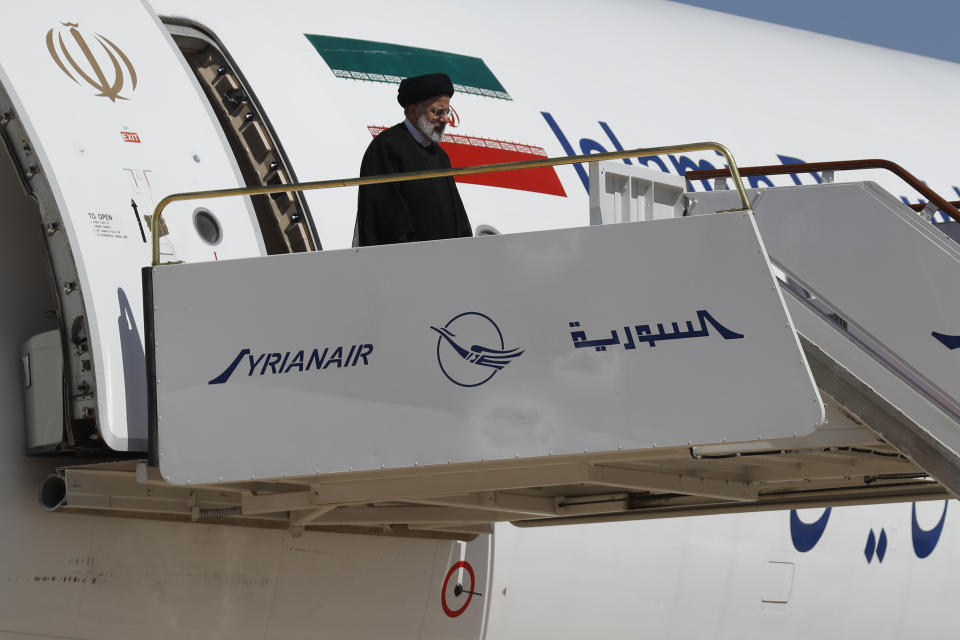 Iranian President Ebrahim Raisi steps off the plane as he arrives to the airport in Damascus, Syria, Wednesday, May 3, 2023. It is the first visit by an Iranian head of state to war-torn Syria since the beginning of the country's uprising-turned-civil-war in 2011, in which Tehran helped tip the balance of power to the government. (AP Photo/Omar Sanadiki)