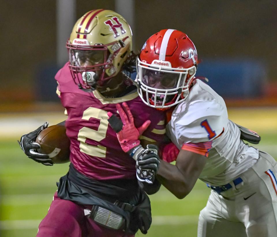 Hartfield Academy's Bralan Womack is tackled by Jackson Prep's Micah Stallworth during the MAIS 6-A championship game at Mississippi College in Clinton, Miss., Saturday, Nov. 18, 2023.