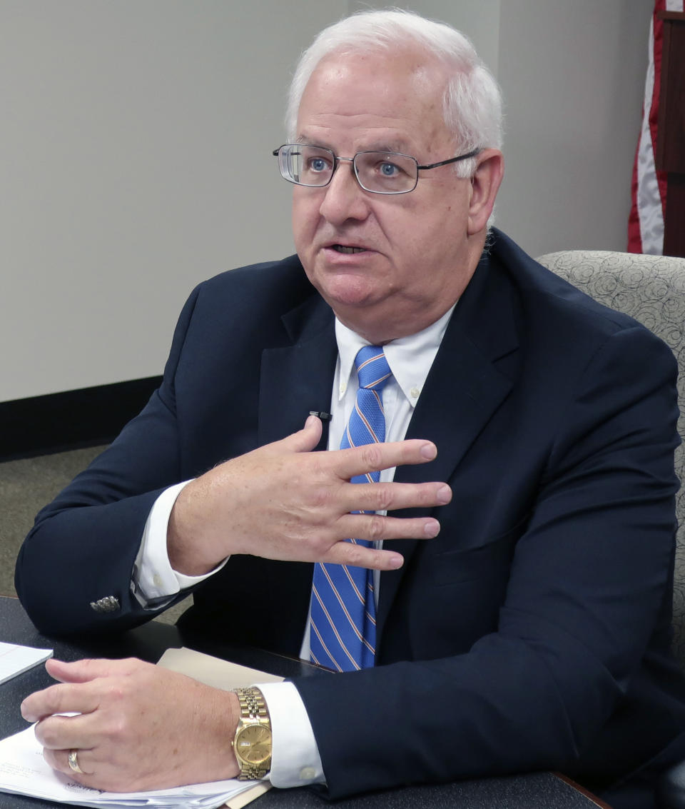 Kansas Revenue Secretary Mark Burghart discusses a new policy that will require out-of-state businesses to collect the state's sales tax on online sales to Kansas residents, during an interview with reporters, Wednesday, Aug. 7, 2019, in Topeka, Kan.. The new policy takes effect in October and some tax experts are calling it the most aggressive in the nation for collecting state and local taxes on online sales. (AP Photo/John Hanna)