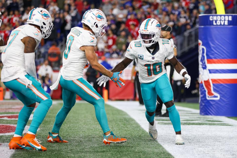 Miami Dolphins receiver Tyreek Hill (10) celebrates after scoring a touchdown during the first half against the New England Patriots at Gillette Stadium.