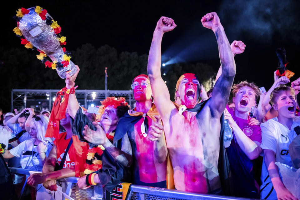 Fans at a fan fest in Berlin celebrate during a round of sixteen match between Germany and Denmark at the Euro 2024 soccer tournament in Dortmund, Germany, Saturday, June 29, 2024. (Christoph Soeder/dpa via AP)