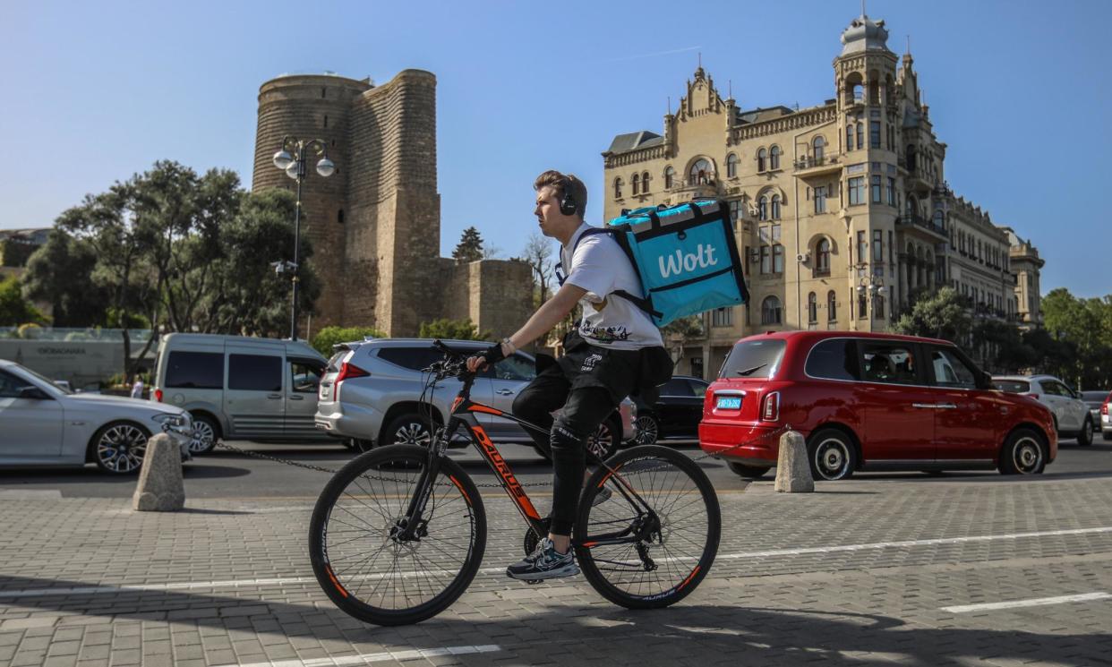 <span>A man rides a rental bike in Baku, Azerbaijan, where the UN climate change conference will convene in November.</span><span>Photograph: Aziz Karimov/Getty Images</span>