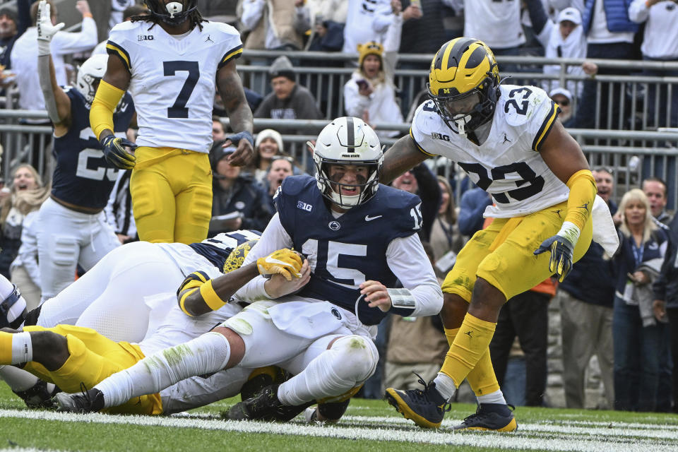 Penn State quarterback Drew Allar (15) scores a touchdown against Michigan during the first half of an NCAA college football game, Saturday, Nov. 11, 2023, in State College, Pa. (AP Photo/Barry Reeger)