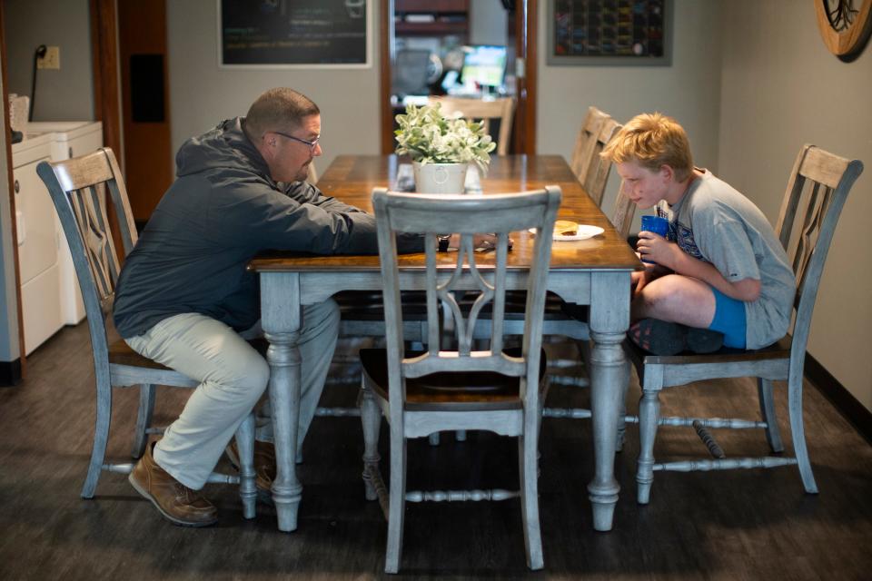 Kyle Hampton, 13, has dinner while Operations Administrator Don Leffler chats with him at the Marion County Family Resource Center. Marion County embraced strategies that try to divert kids from entering detention and youth prisons.