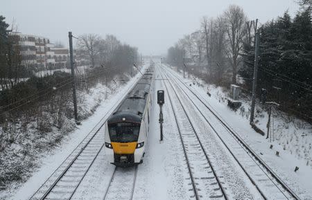 A Thameslink train passes through Harpenden in the snow, Harpenden, Britain, March 2, 2018. REUTERS/Peter Cziborra