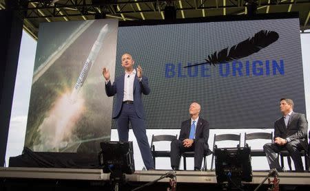 Amazon founder and Blue Origin founder Jeff Bezos (L)announces plans to build a rocket manufacturing plant and launch site at Cape Canaveral Air Force Station, Florida September 15, 2015. HO/Mike Brown/Space Florida