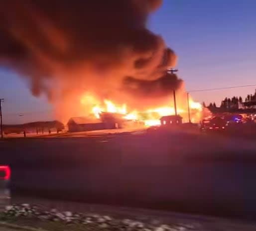 Fire tore through the Covered Bridge Potato Chip Factory in Hartland on Friday evening. Nobody was hurt but firefighters believe the facility was destroyed. (Submitted by Amy Crawford - image credit)