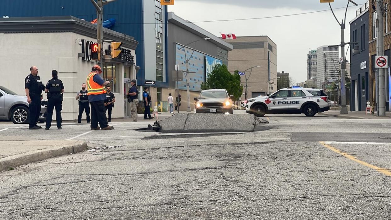 A view of the large hole in the roadway at University Avenue West and Church Street in downtown Windsor on April 29, 2024. (Chris Ensing/CBC - image credit)