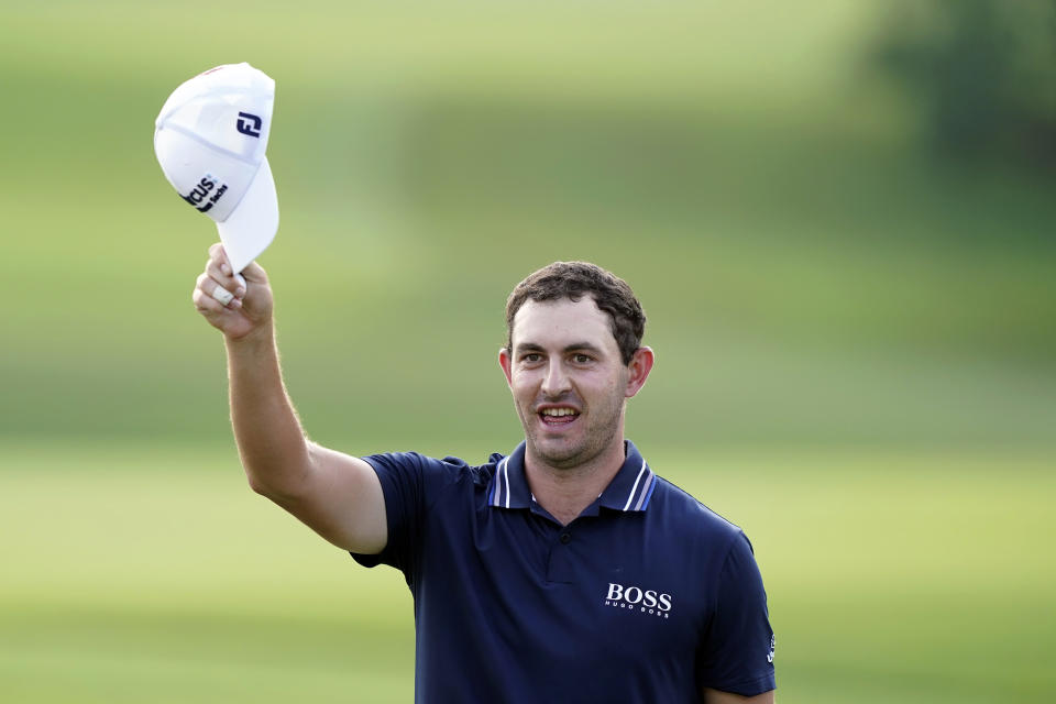 Patrick Cantlay tips his cap to the crowd after winning the Tour Championship golf tournament and the FedEx Cup at East Lake Golf Club, Sunday, Sept. 5, 2021, in Atlanta. (AP Photo/Brynn Anderson)