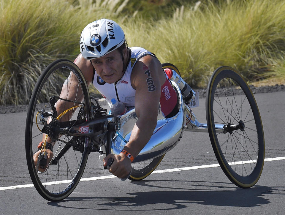 FILE - In this Saturday, Oct. 10, 2015 file photo, Alex Zanardi, of Italy, rides during the cycling portion of the Ironman World Championship Triathlon, in Kailua-Kona, Hawaii. Race car driver turned Paralympic champion Alex Zanardi has been seriously injured again. Police tell The Associated Press that Zanardi was transported by helicopter to a hospital in Siena following a road accident near the Tuscan town of Pienza during a national race for Paralympic athletes on handbikes. The 53-year-old Zanardi had both of his legs amputated following a horrific crash during a 2001 CART race in Germany. He was a two-time CART champion. (AP Photo/Mark J. Terrill, File)