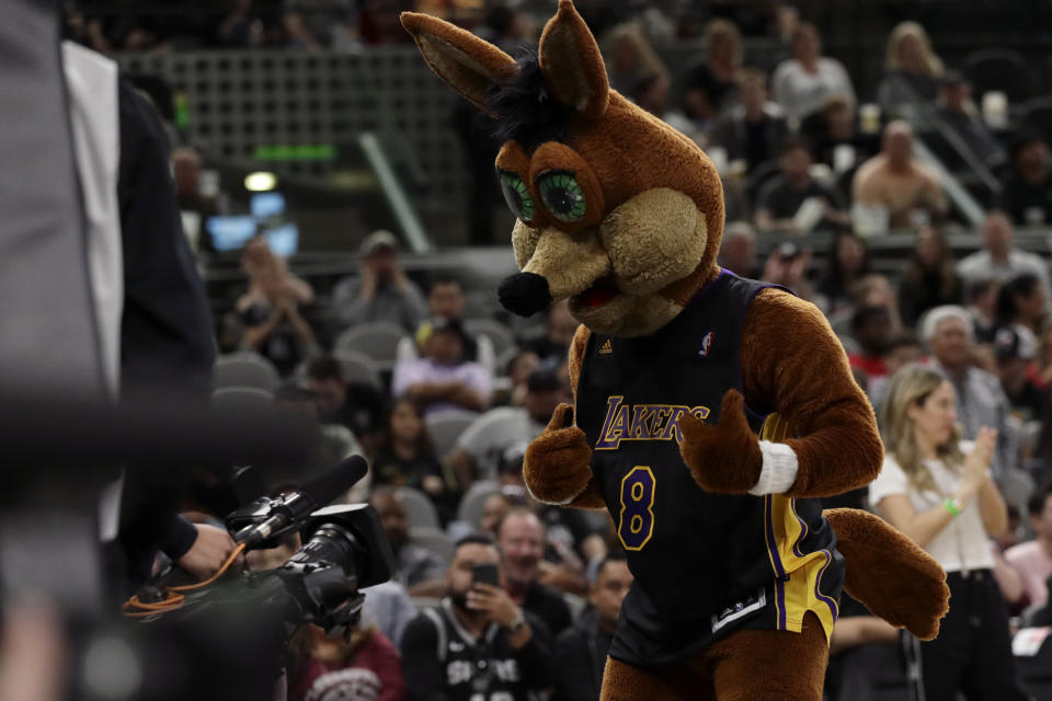 The Coyote, the San Antonio Spurs mascot, wears a Los Angeles Lakers jersey to honour former NBA player Kobe Bryant during the second half of an NBA basketball game between the Spurs and the Toronto Raptors in San Antonio, Sunday, Jan. 26, 2020. (AP Photo/Eric Gay)