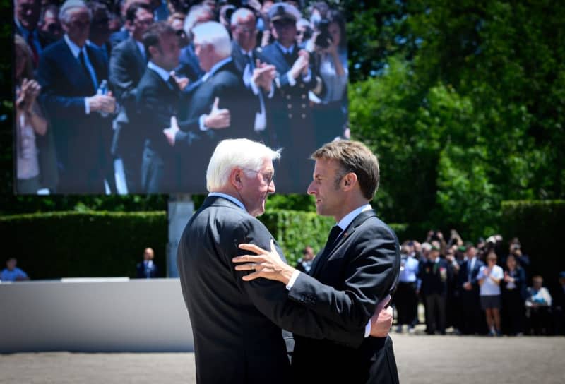 German President Frank-Walter Steinmeier (L) and French President Emmanuel Macron embrace during the memorial service in the martyred village of Oradour-sur-Glane as they remember the victims of the 1944 SS massacre.  On June 10, 1944, members of the SS division "That Reich" murdered 643 civilians in Oradour-sur-Glane and completely destroyed the village.  Bernd von Jutrczenka/dpa