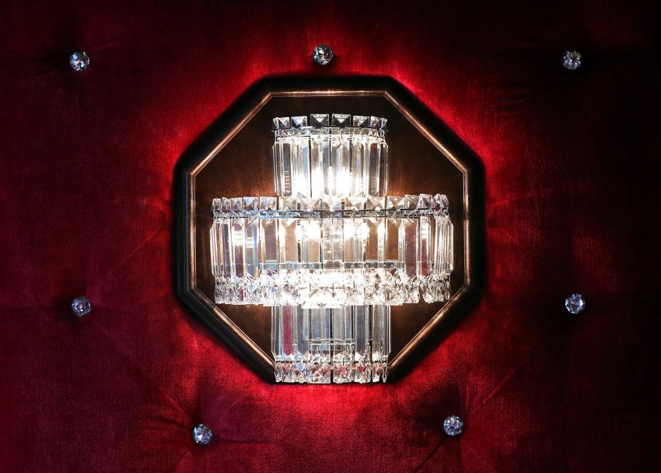 Light fixtures hang on red cushioned walls in the private room at Lanning's Restaurant.