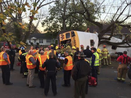 Rescue officials at the scene of a school bus crash involving several fatalities in Chattanooga, Tennessee, U.S., November 21, 2016. Courtesy of Chattanooga Fire Dept/Handout via REUTERS