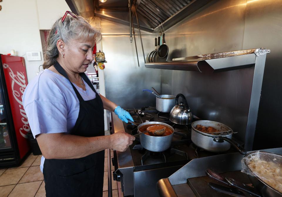Imelda Parra prepares food at their restaurant El Asadero in Salt Lake City on Friday, Oct. 27, 2023. The restaurant will be displaced by a new apartment complex. | Jeffrey D. Allred, Deseret News