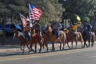 FILE - Supporters of President Donald Trump ride horses outside the Statehouse in Santa Fe, N.M., on Wednesday, Jan. 6, 2021, to protest President-elect Joe Biden's electoral victory. A rural New Mexico county’s initial refusal to certify its primary election results sent ripples across the country last week, a symbol of how even the most elemental functions of democracy have become politicized pressure points amid the swirl of lies stemming from the 2020 presidential outcome. (AP Photo/Morgan Lee, File)