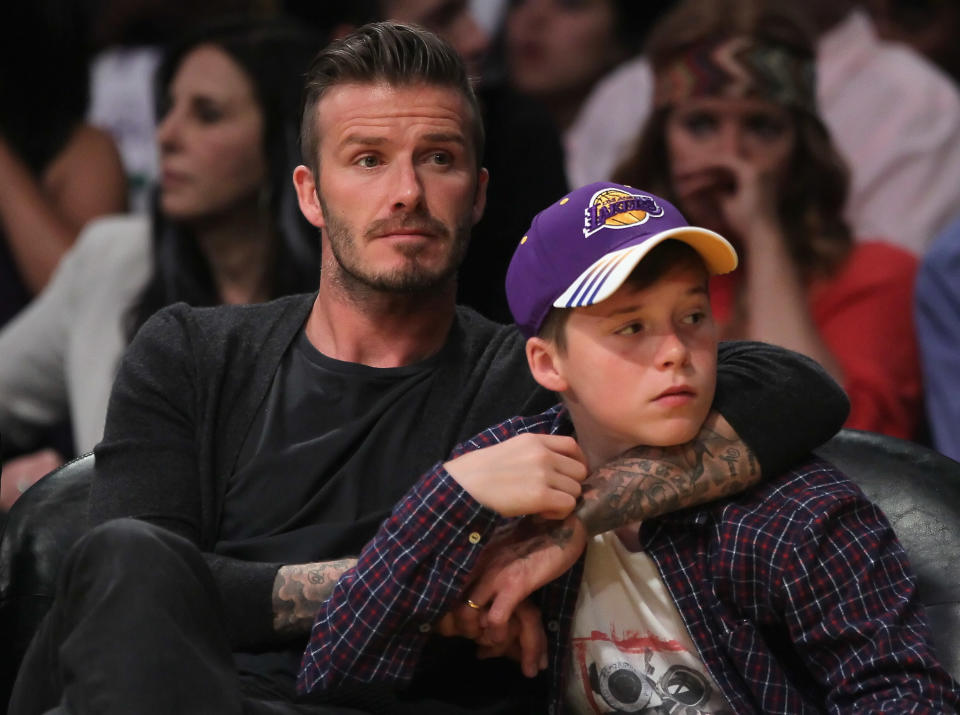 LOS ANGELES, CA - APRIL 29: David Beckham and son Brooklyn take in Game One of the Western Conference Quarterfinals between the Los Angeles Lakers and the Denver Nuggets in the 2012 NBA Playoffs on April 29, 2012 at Staples Center in Los Angeles, California. The Lakers defeated the Nuggets 103-88. NOTE TO USER: User expressly acknowledges and agrees that, by downloading and or using this photograph, User is consenting to the terms and conditions of the Getty Images License Agreement. (Photo by Jeff Gross/Getty Images)