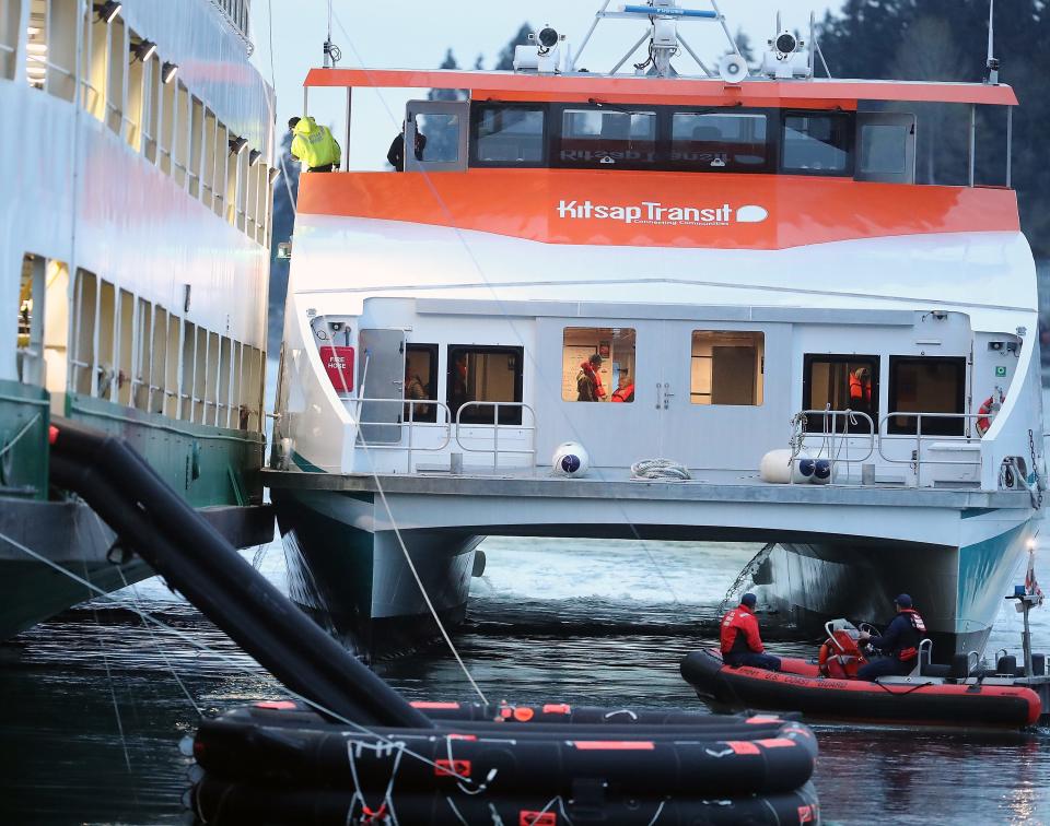 Passengers aboard the Washington State Ferry Walla Walla disembark and board Kitsap Transit's Commander passenger ferry after it docked against the beached ferry to transfer the stranded passengers on April 15.